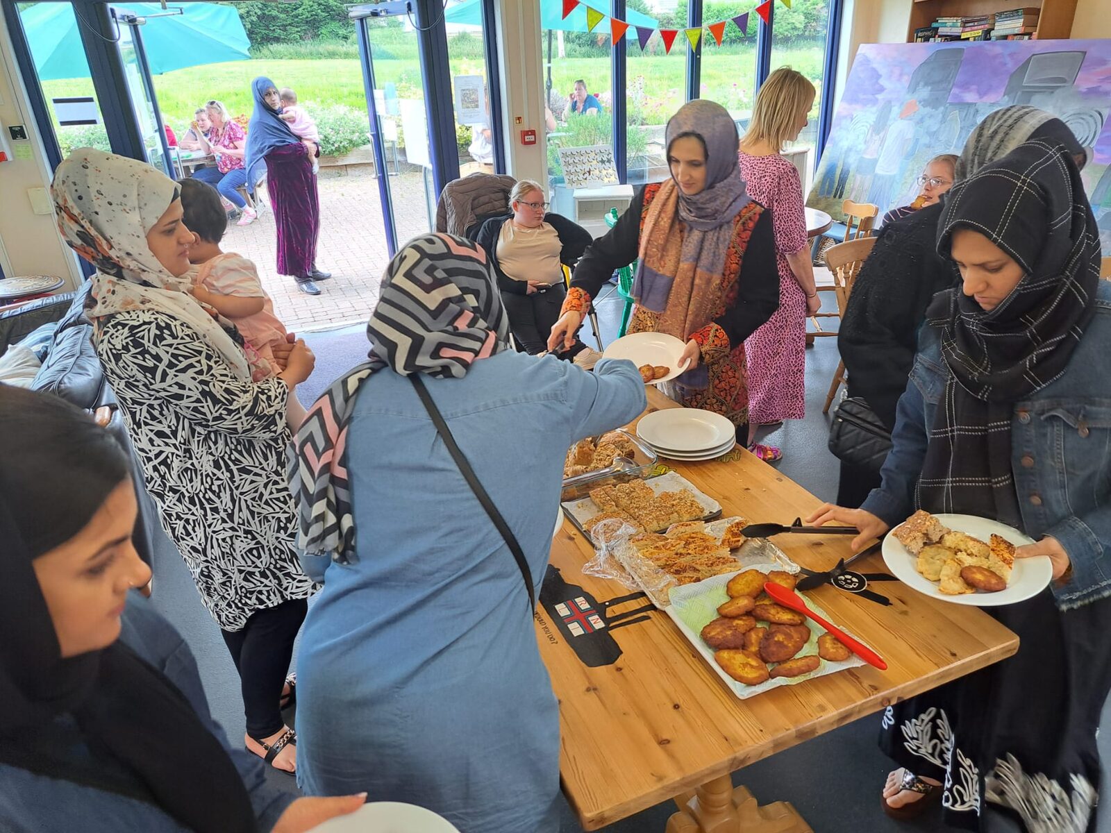 People sharing food together at a community welcome event