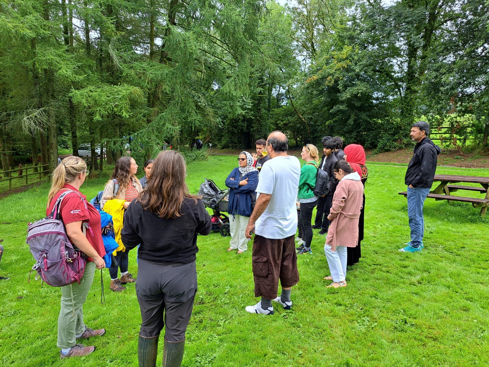 A group in discussion outdoors at a community gathering